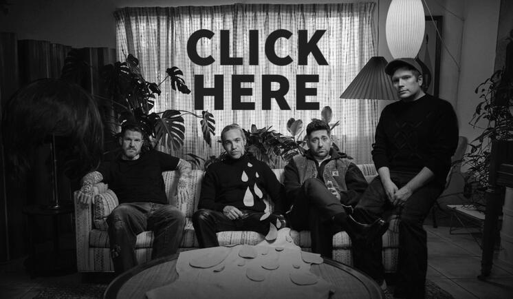 This image is a hyperlink! It's a photo of Fall Out Boy sitting on a sofa facing the camera.